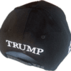 A black hat with the word " trump " on it.