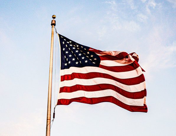 A flag that is flying in the wind.